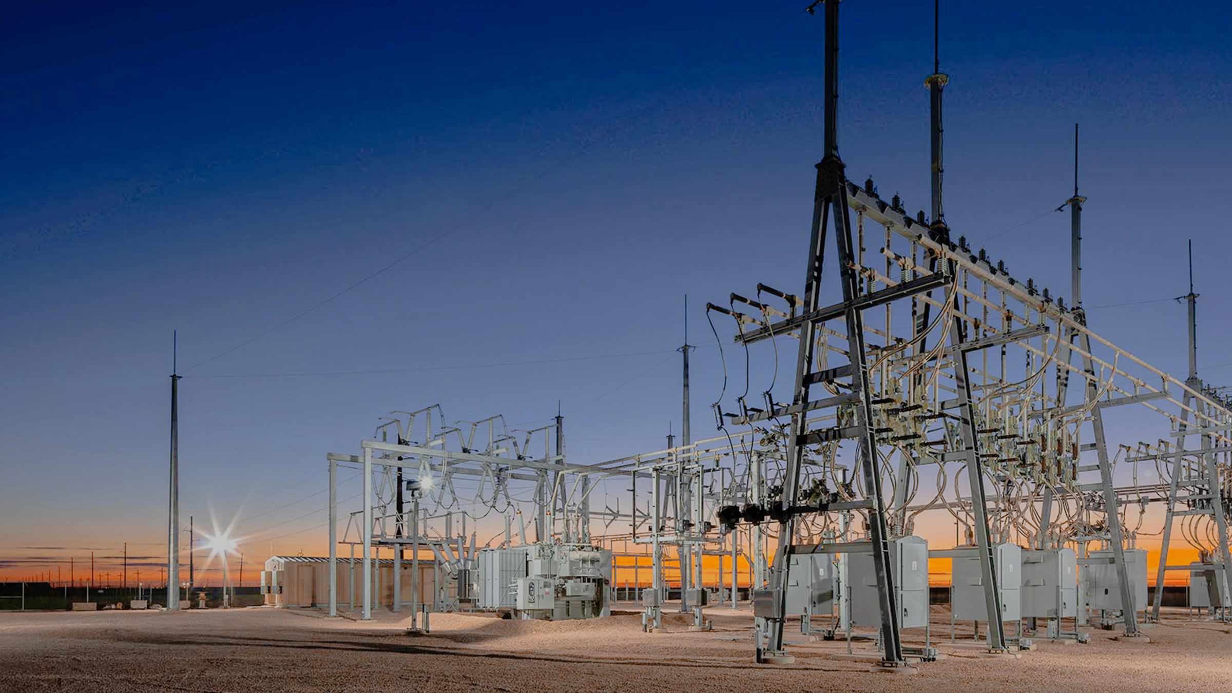 Electrical substation equipment at sunset.